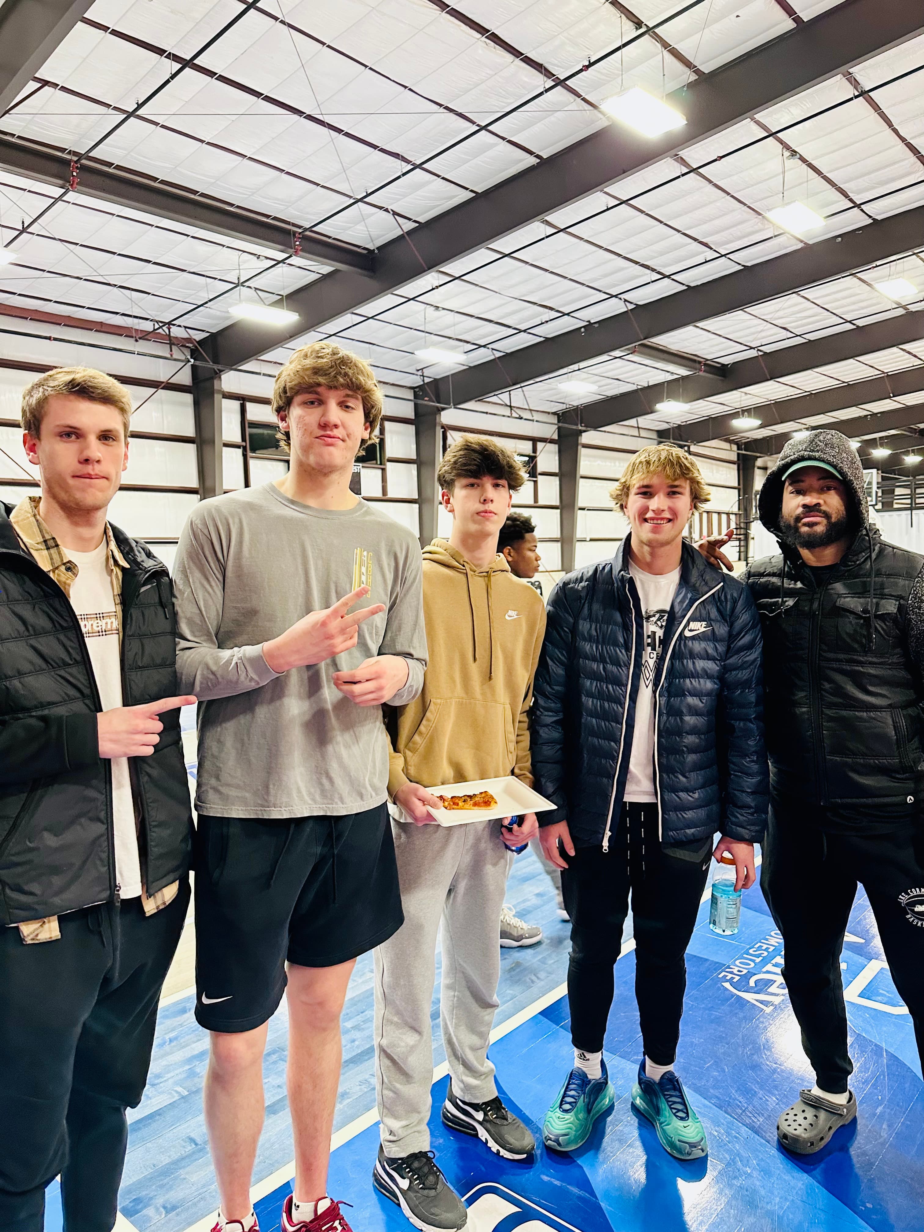 Teens posing on the hardwood at their birthday party
