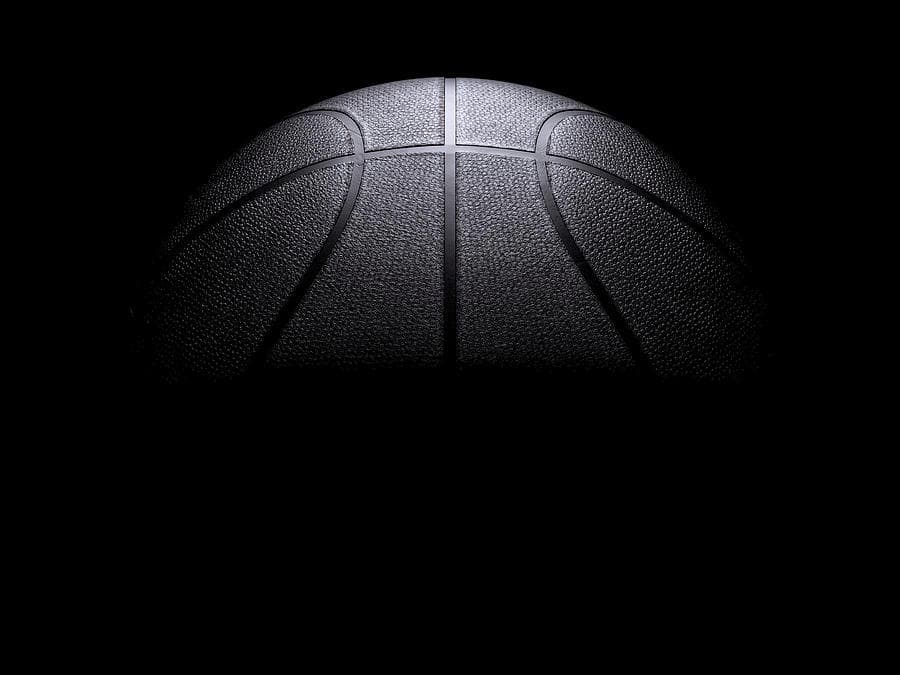 Basketball lit dramatically against a black background