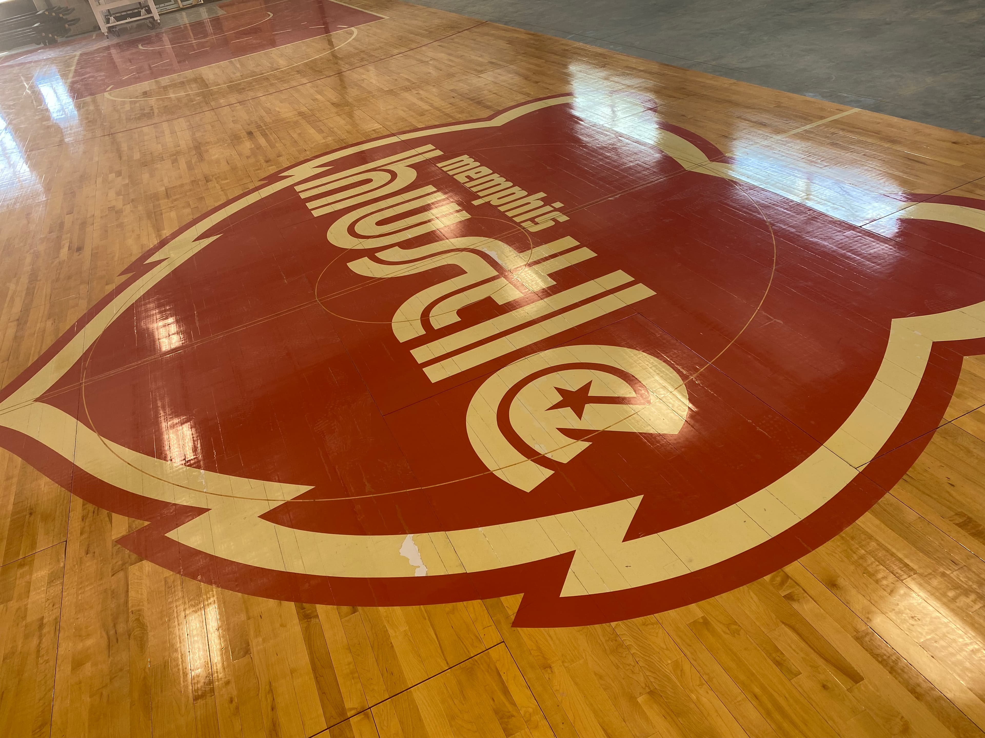 Reclaimed Memphis Hustle floor — the Landers Center hardwood at The Fieldhouse