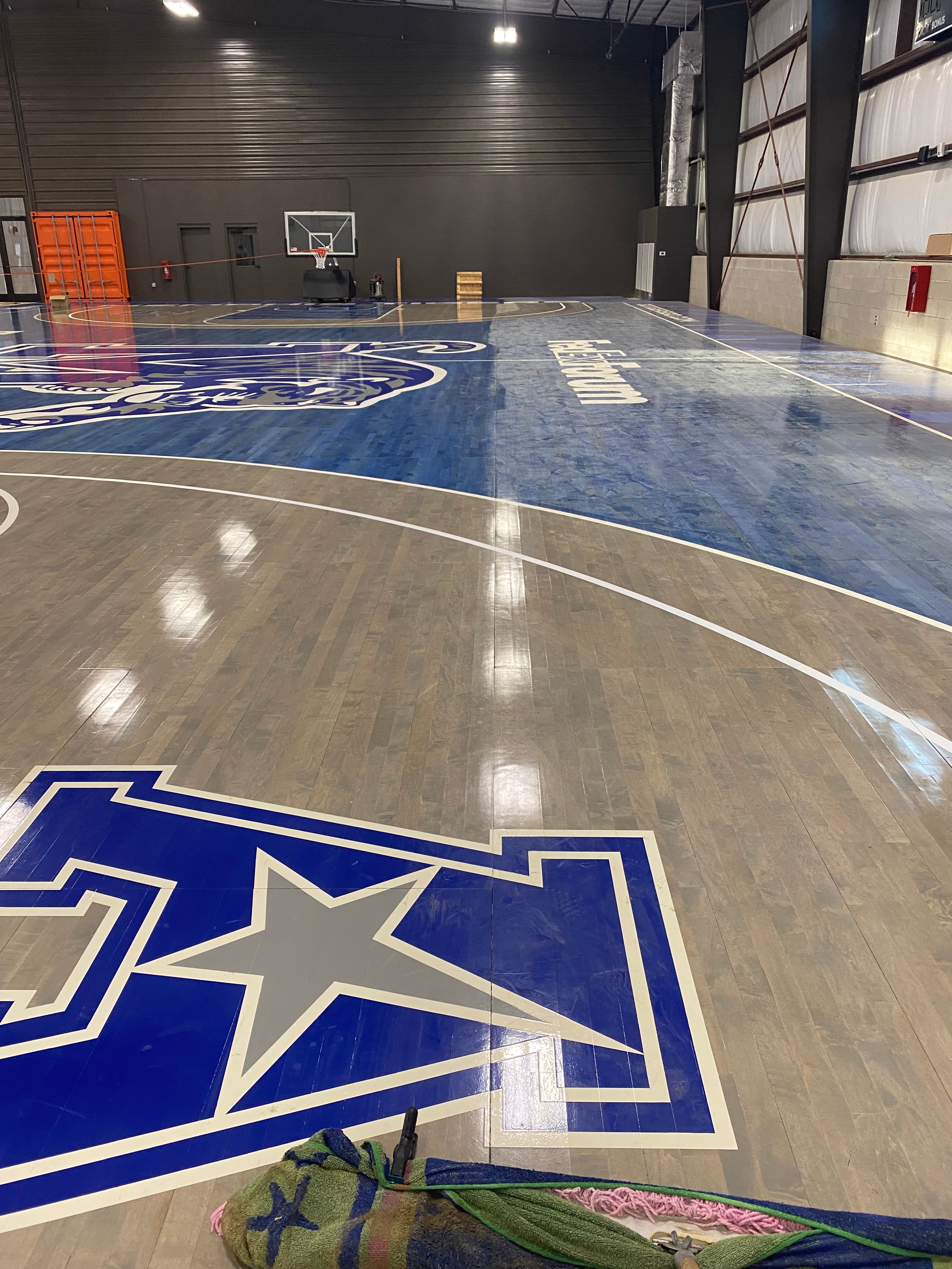 Memphis Tigers 'A' logo painted into the reclaimed hardwood