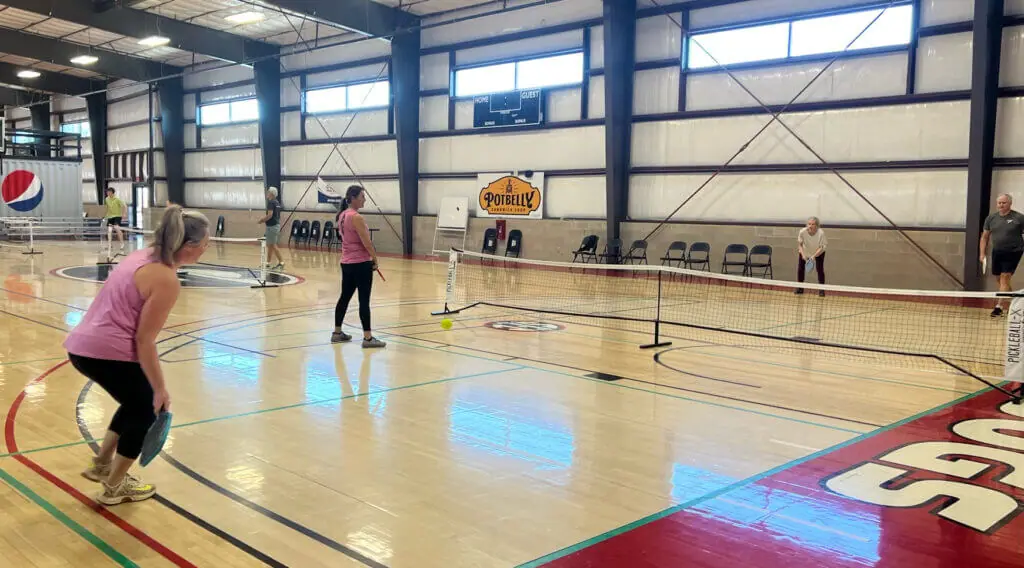 Pickleball players mid-rally on the indoor courts at the Fieldhouse